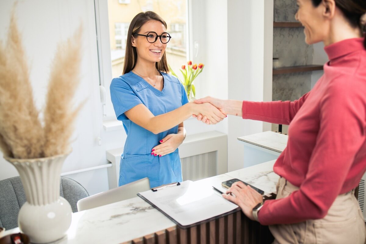 happy patient and practice receptionist