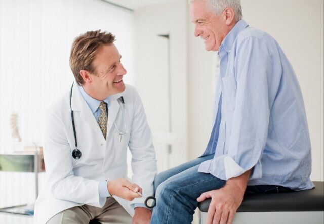 happy patient talking to doctor image