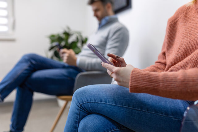Patients in the waiting room using digital check-in by Solutionreach to let the staff know they are ready for their appointment.