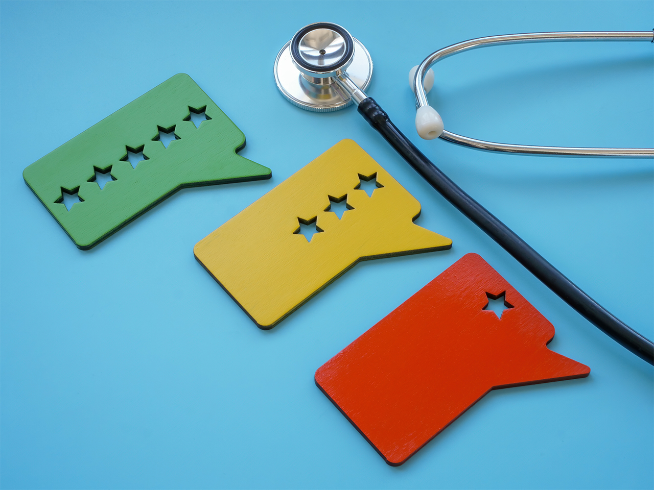 Patient experience ratings ranging from high to low beside a stethoscope, illustrating how payment workflows can impact overall satisfaction in healthcare.