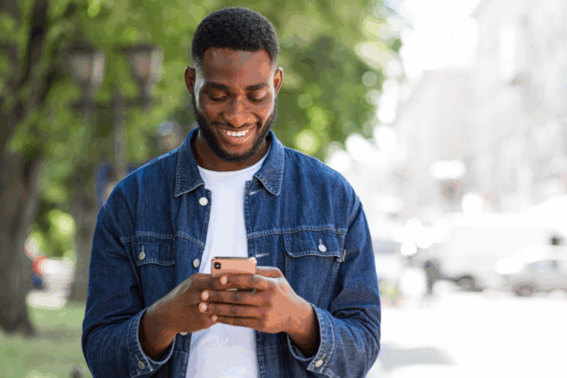 Patient using a smartphone to engage with automated healthcare communication powered by Solutionreach.