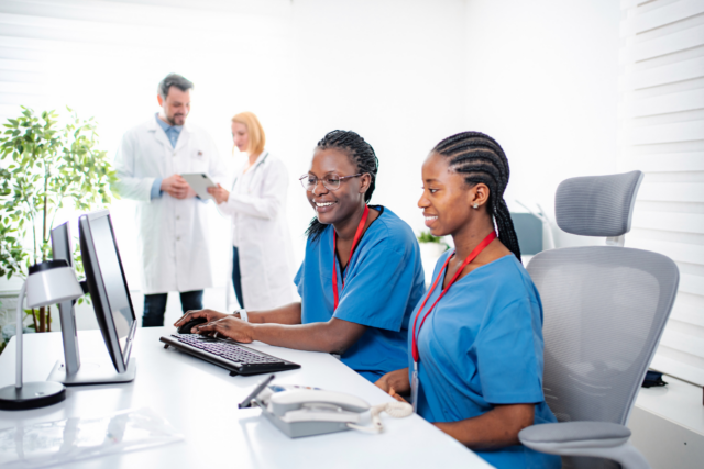 Image of healthcare practice front desk team receiving intake forms from patient electronically
